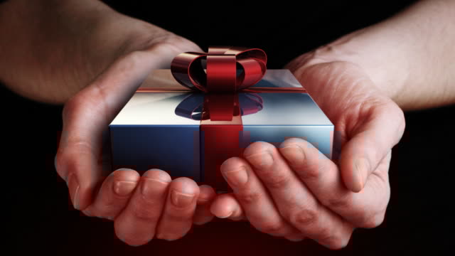Hands opening to reveal a gift.